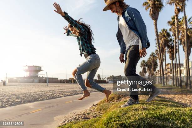 happy and freedom couple having fun - venice beach stock pictures, royalty-free photos & images