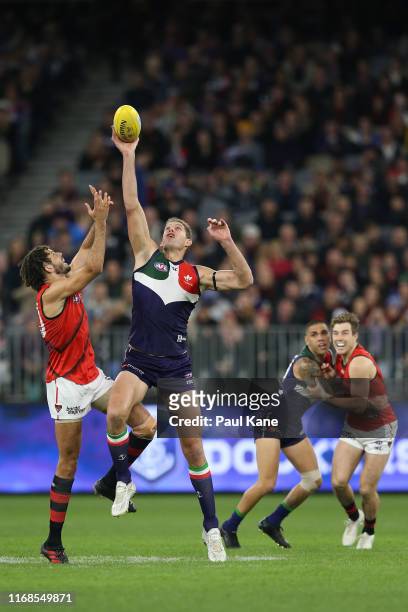 Zac Clarke of the Bombers and Aaron Sandilands of the Dockers contest the ruck during the round 22 AFL match between the Fremantle Dockers and the...