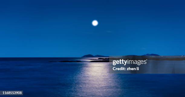 the moon rises from the sea - rocky star stock pictures, royalty-free photos & images