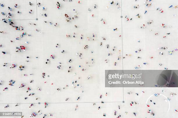 high angle view of people on street - städtischer platz stock-fotos und bilder