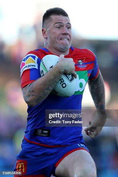 Shaun Kenny-Dowall of the Newcastle Knights makes a break with the ball during the round 22 NRL match between the Newcastle Knights and the North...