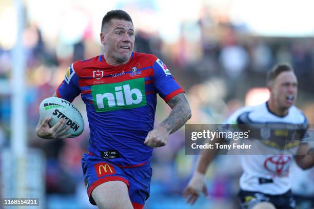 Shaun Kenny-Dowall of the Newcastle Knights makes a break with the ball during the round 22 NRL match between the Newcastle Knights and the North...