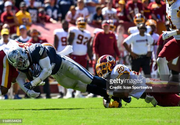Dallas Cowboys running back Ezekiel Elliott is stopped on a second quarter run by Washington Redskins strong safety Landon Collins in action on...