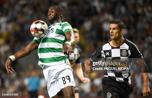 Sporting Lisbon's Congolese forward Yannick Bolasie controls the ball next to Boavista's Portuguese defender Ricardo Costa during the Portuguese...