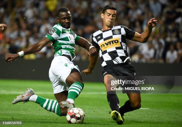 Sporting Lisbon's Congolese forward Yannick Bolasie vies with Boavista's Portuguese defender Ricardo Costa during the Portuguese league football...