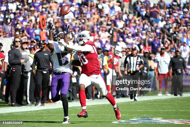 Marquise Brown of the Baltimore Ravens makes a catch over Tramaine Brock of the Arizona Cardinals during the second half at M&T Bank Stadium on...