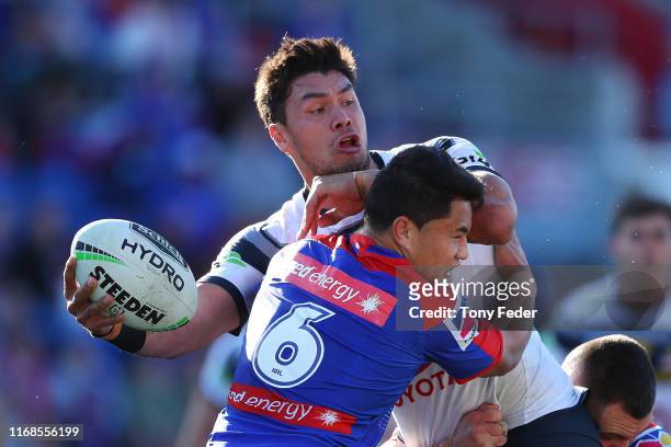 Jordan McLean of the North Queensland Cowboys is tackled during the round 22 NRL match between the Newcastle Knights and the North Queensland Cowboys...