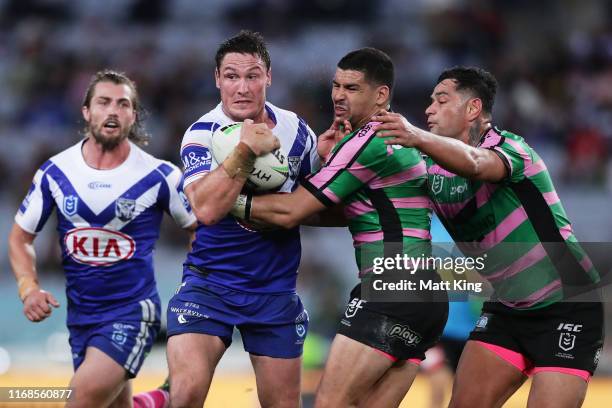 Josh Jackson of the Bulldogs is tackled during the round 22 NRL match between the South Sydney Rabbitohs and the Canterbury Bulldogs at ANZ Stadium...