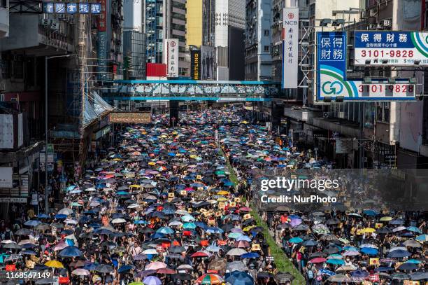Protester are seen holding up umbrellas during a march in Hong Kong on September 15 Protester lady clash with Police with Police firing tear gas and...