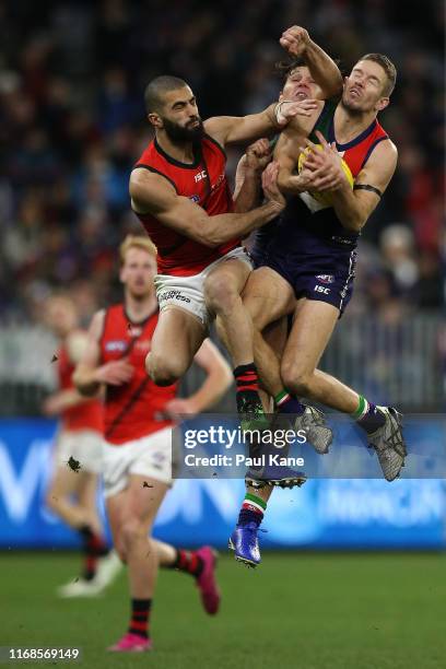 Sam Switkowski of the Dockers marks the ball against Adam Saad of the Bombers during the round 22 AFL match between the Fremantle Dockers and the...