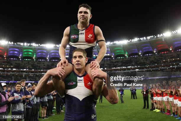 Aaron Sandilands of the Dockers carries Hayden Ballantyne thru a guard of honour after playing their final games for the club during the round 22 AFL...