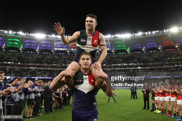 Aaron Sandilands of the Dockers carries Hayden Ballantyne thru a guard of honour after playing their final game for the club at home during the round...