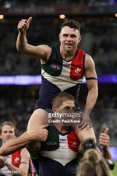 Aaron Sandilands of the Dockers carries Hayden Ballantyne thru a guard of honour after playing their final game for the club at home during the round...