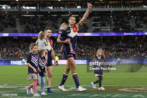 Hayden Ballantyne and Aaron Sandilands of the Dockers walk a lap of honour after playing their final game at home for the club during the round 22...