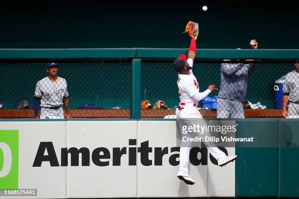 Marcell Ozuna of the St. Louis Cardinals attempts to catch a home run against the Milwaukee Brewers in the seventh inning at Busch Stadium on...