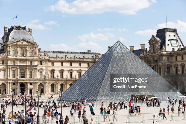 Paris, France, August 31, 2019. A view of the pyramid of the Louvre in the Napoleon courtyard by day in good weather.