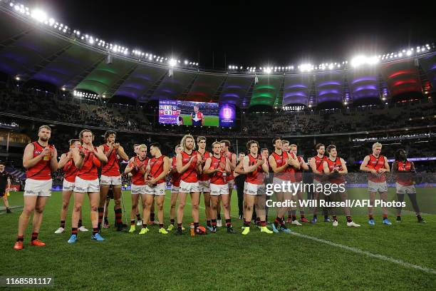 Bombers players acknowledge retiring players Aaron Sandilands and Hayden Ballantyne of the Dockers during the round 22 AFL match between the...