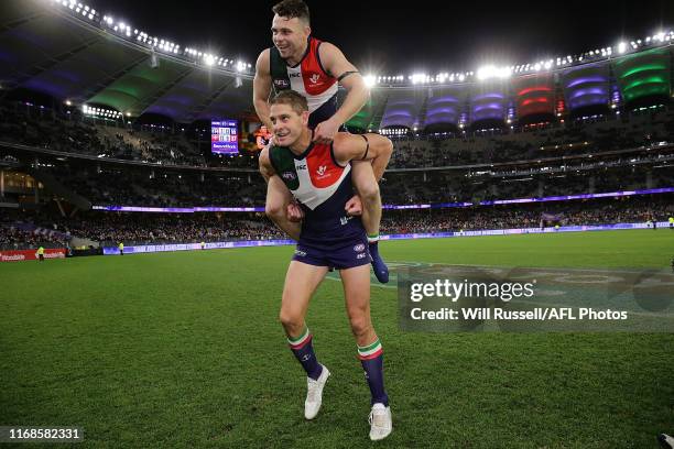 Aaron Sandilands carries Hayden Ballantyne of the Dockers on his shoulders after the round 22 AFL match between the Fremantle Dockers and the...