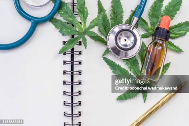 cannabis essential oil container with cannabis leaves and cannabis seeds - brain in a jar stock pictures, royalty-free photos & images