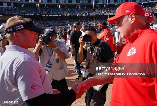 Head coach Jon Gruden of the Oakland Raiders shakes hand with head coach Andy Reid of the Kansas City Chiefs after the Chiefs defeated the Raiders...