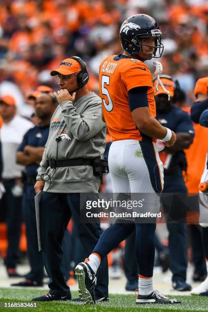 Joe Flacco of the Denver Broncos turns as he walks off the field near head coach Vic Fangio in the fourth quarter of a game against the Chicago Bears...