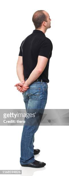 rear view of man standing against white background - rückansicht stock-fotos und bilder