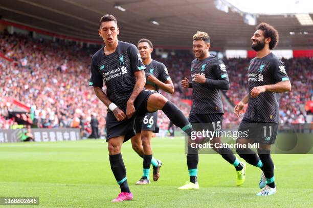 Roberto Firmino of Liverpool celebrates with team mates Mohamed Salah, Alex Oxlade-Chamberlain and Trent Alexander-Arnold after scoring his team's...