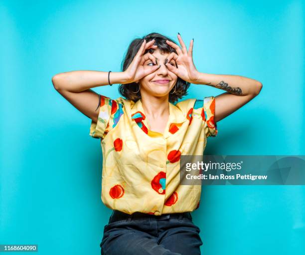young woman making funny faces - studioaufnahme stock-fotos und bilder