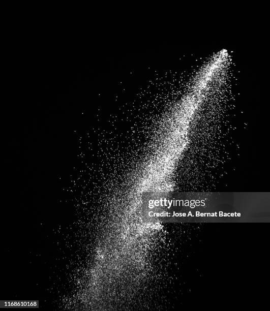 explosion by an impact of a cloud of particles of powder of color white on a black background. - puder stock-fotos und bilder