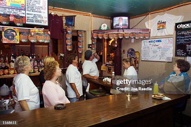 People watch the television as President George W. Bush announces from the White House, that the U.S. And Britain had started bombing Afghanistan...