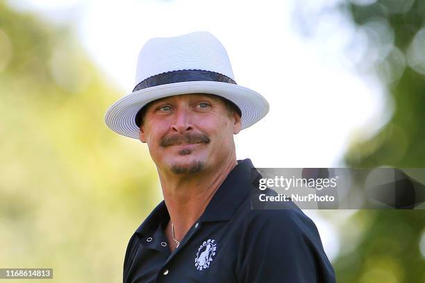 Michigan native musician Kid Rock follows his shot from the 15th tee during the celebrity shootout after the conclusion of the second round of The...