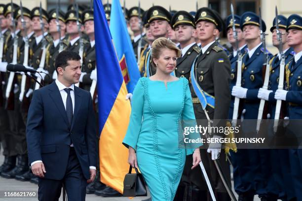 Ukraine's President Volodymyr Zelensky and his Slovakian counterpart Zuzana Caputova review the Ukrainian guard of honour during a welcome ceremony...