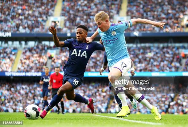 Kevin De Bruyne of Manchester City challenges for the ball with Kyle Walker-Peters of Tottenham Hotspur during the Premier League match between...