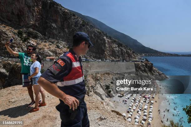 Turkish gendarmerie patrols as people take selfies in Kaputas beach on August 17, 2019 in Kas, Turkey. Turkey’s resort towns saw a 100 percent...