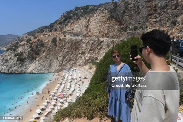 Tourist pose for a selfie in Kaputas beach on August 17, 2019 in Kas, Turkey. Turkey’s resort towns saw a 100 percent occupancy rate with the Eid...