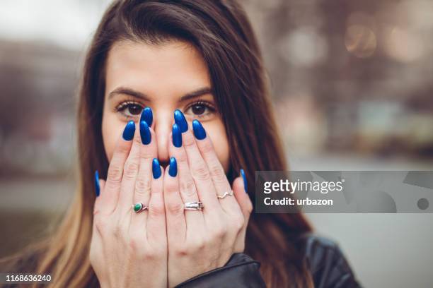 portrait of pretty young girl - blue nail polish stock pictures, royalty-free photos & images