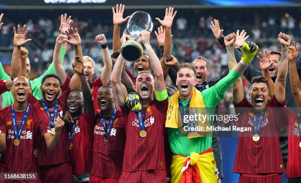 Jordan Henderson of Liverpool lifts the UEFA Super Cup trophy as Liverpool celebrate victory following the UEFA Super Cup match between Liverpool and...