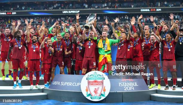 Jordan Henderson of Liverpool lifts the UEFA Super Cup trophy as Liverpool celebrate victory following the UEFA Super Cup match between Liverpool and...