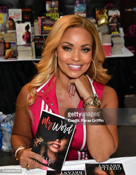 Personality Gizelle Bryant signs copies of her new book "My World" during the 2019 Bronner Brothers International Beauty Show at the Georgia World...