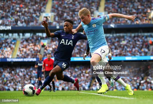 Kevin De Bruyne of Manchester City challenges for the ball with Kyle Walker-Peters of Tottenham Hotspur during the Premier League match between...