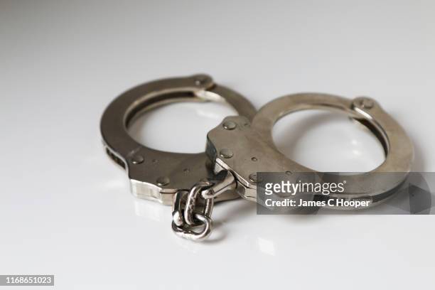 handcuffs 1 - criminology stock pictures, royalty-free photos & images
