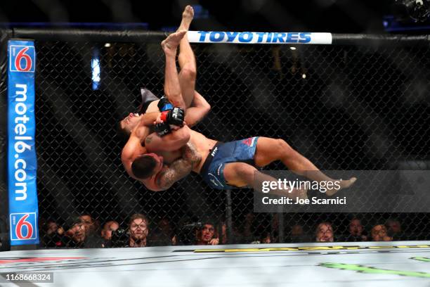 Christos Glagos is slammed onto the ground by Drakkar Klose in the third round during their Lightweight Bout at UFC 241 at Honda Center on August 17,...