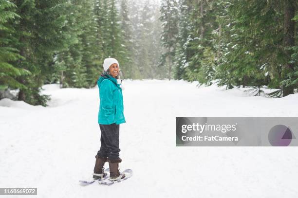 portrait of a senior woman snowshoeing - winter sport walk old stock pictures, royalty-free photos & images