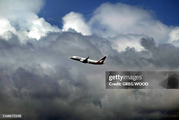 Qantas domestic passenger plane takes off from Sydney airport into a bank of storm clouds, 19 February 2003. It was reported here Wednesday that...