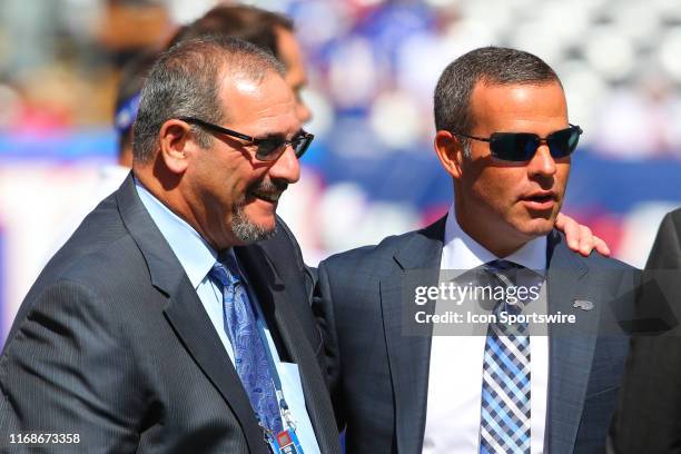 New York Giants general manager Dave Gettleman and Buffalo Bills general manager Brandon Beane on the field prior to the National Football League...