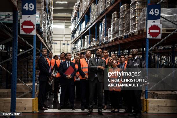 French Prime Minister Edouard Philippe looks up during a visit to the ID Logistics platform in Aulnay-sous-Bois, northeast of Paris on September 16,...