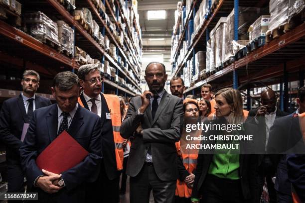 French Prime Minister Edouard Philippe gestures during a visit to the ID Logistics platform in Aulnay-sous-Bois, northeast of Paris on September 16,...