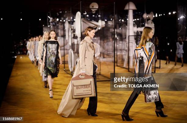 Models present creations during a catwalk show for the Burberry Spring/Summer 2020 collection on the fourth day of London Fashion Week in London on...