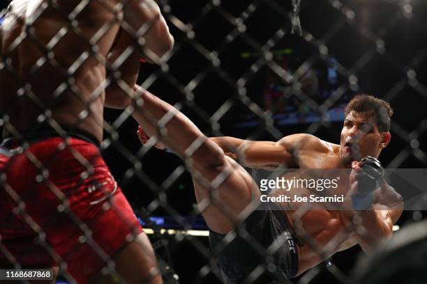 Paulo Costa sends a kick to Yoel Romero in the first round during their Middleweight Bout at UFC 241 at Honda Center on August 17, 2019 in Anaheim,...