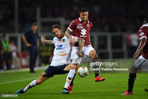 Armando Izzo of Torino FC competes with Andrea Tabanelli of US Lecce during the Serie A match between Torino FC and US Lecce at Stadio Olimpico di...